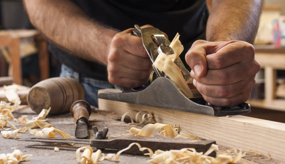 a man preparing a handmade furniture element